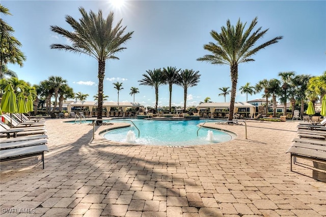 view of pool with a patio area and pool water feature