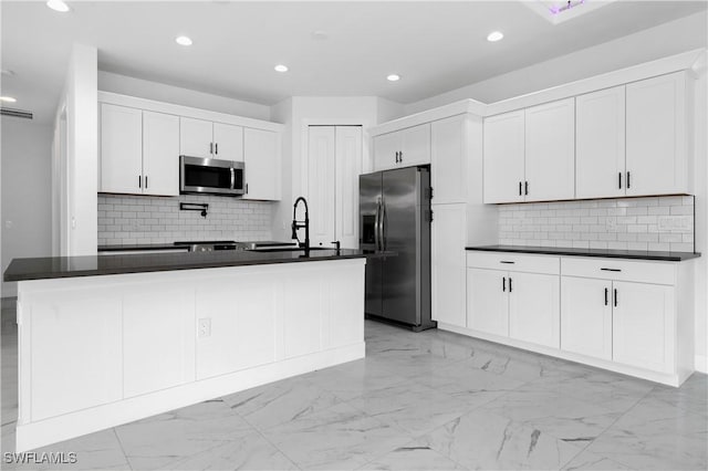 5300 3rd St W, Lehigh Acres, FL 33971 - kitchen featuring appliances with stainless steel finishes, dark countertops, a sink, backsplash, and recessed lighting