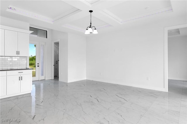 unfurnished dining area featuring a notable chandelier, coffered ceiling, beam ceiling, and crown molding