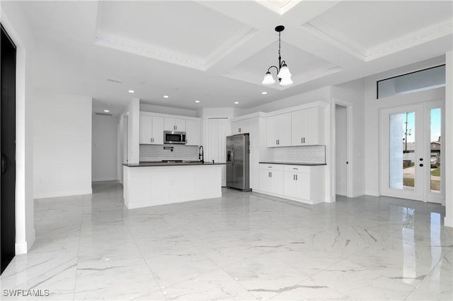 kitchen with coffered ceiling, white cabinets, pendant lighting, and stainless steel appliances