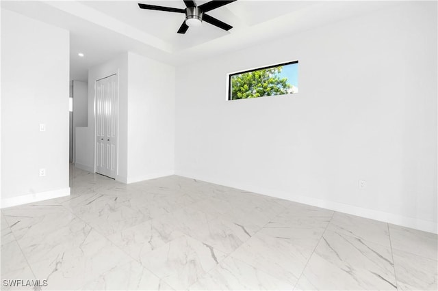 5300 3rd St W, Lehigh Acres, FL 33971 - unfurnished room with baseboards, ceiling fan, marble finish flooring, recessed lighting, and a raised ceiling