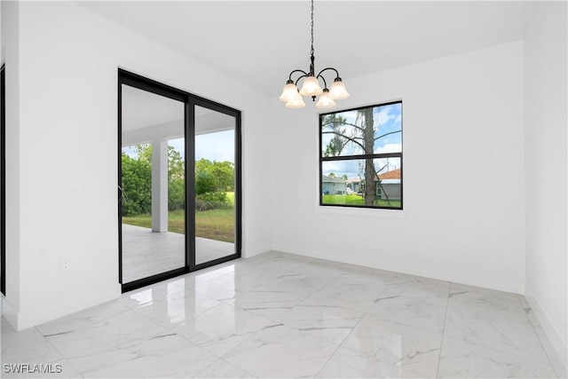 unfurnished room with an inviting chandelier