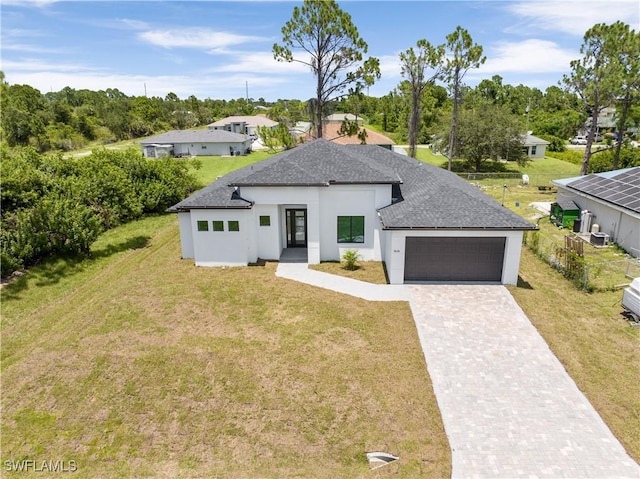 view of front of property with a garage and a front yard