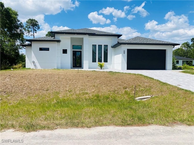 5300 3rd St W, Lehigh Acres, FL 33971 - prairie-style home featuring a garage, stucco siding, driveway, and a front lawn