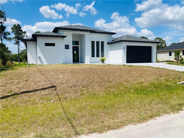 5300 3rd St W, Lehigh Acres, FL 33971 - prairie-style home with driveway, a garage, stucco siding, and a front lawn