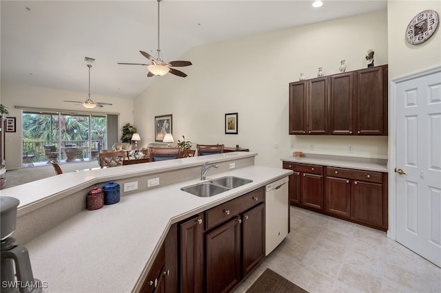 kitchen with sink, dishwasher, dark brown cabinetry, and vaulted ceiling