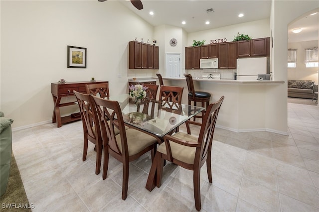 dining space with ceiling fan and light tile patterned flooring