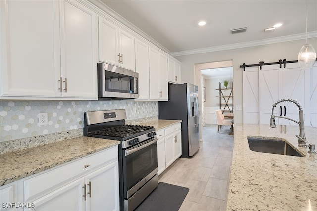 kitchen featuring white cabinetry, stainless steel appliances, sink, and decorative backsplash