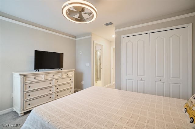 bedroom featuring ornamental molding, light carpet, and a closet