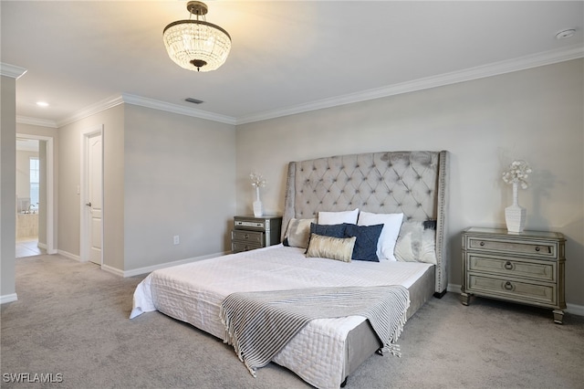 carpeted bedroom with ensuite bathroom and ornamental molding