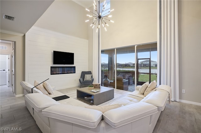 living room featuring washer / dryer and a chandelier