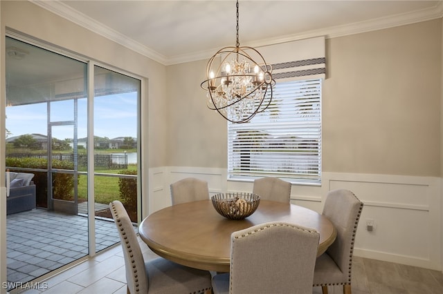 tiled dining room featuring ornamental molding and a notable chandelier