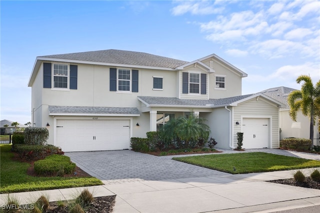 view of front of home featuring a garage and a front yard