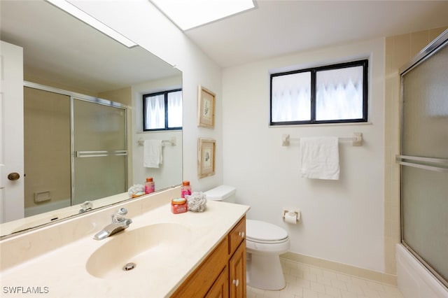 full bathroom featuring vanity, toilet, shower / bath combination with glass door, and tile patterned flooring