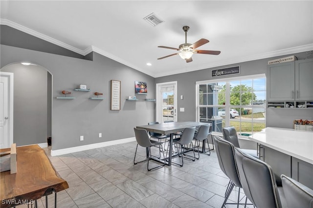 dining area with ceiling fan, crown molding, and lofted ceiling