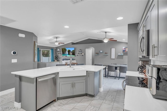 kitchen with stainless steel appliances, sink, vaulted ceiling, ceiling fan, and gray cabinetry