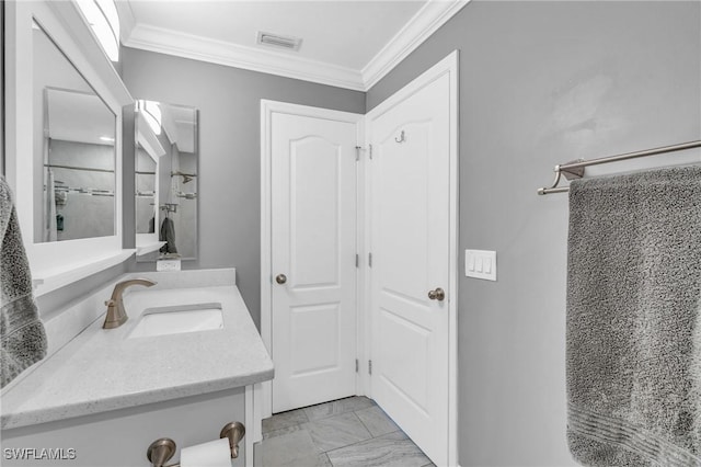 bathroom with ornamental molding, vanity, and a shower