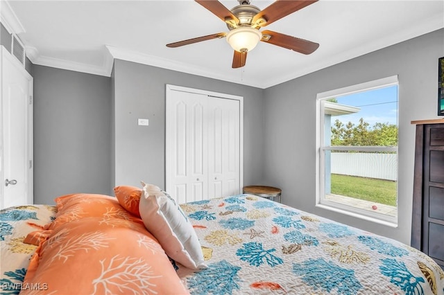 bedroom featuring multiple windows, a closet, and ceiling fan