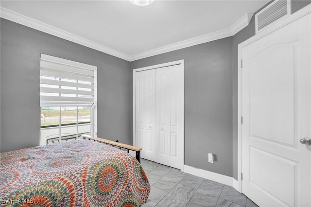 bedroom with a closet and crown molding