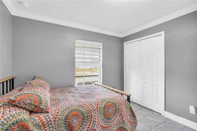 bedroom featuring light tile patterned floors, a closet, and ornamental molding