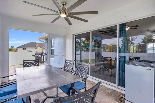 sunroom with ceiling fan and plenty of natural light