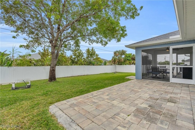 view of yard with a patio and ceiling fan