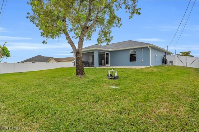 rear view of house featuring a lawn and a sunroom