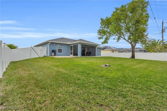 back of house with a patio area and a yard