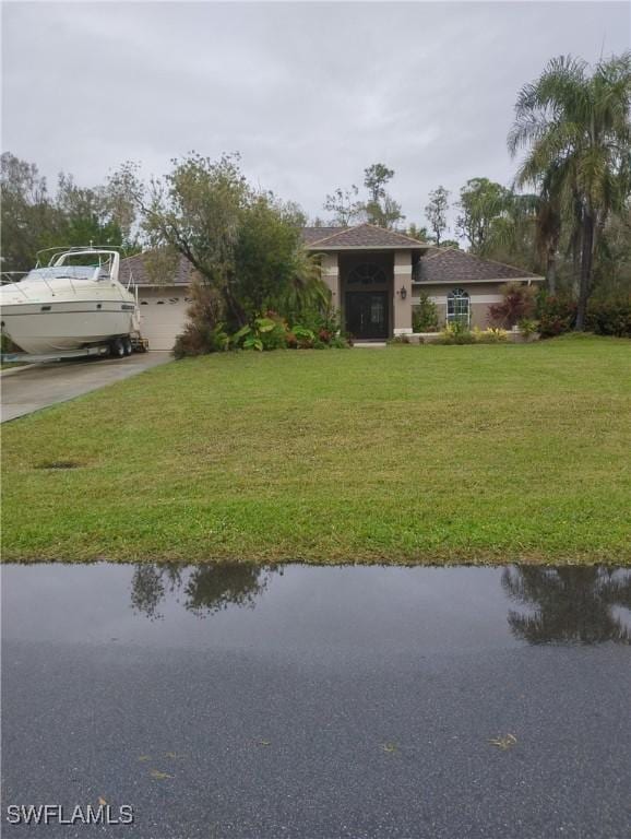 view of yard featuring a water view and a garage