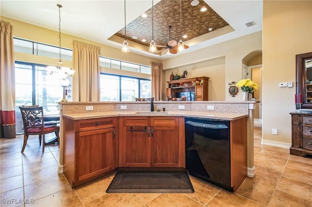 kitchen featuring sink, a tray ceiling, a wealth of natural light, and black dishwasher