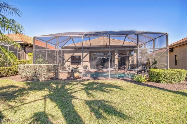 rear view of house featuring a patio, a lanai, and a yard