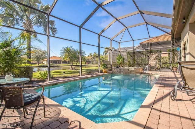 view of pool with a patio area and glass enclosure