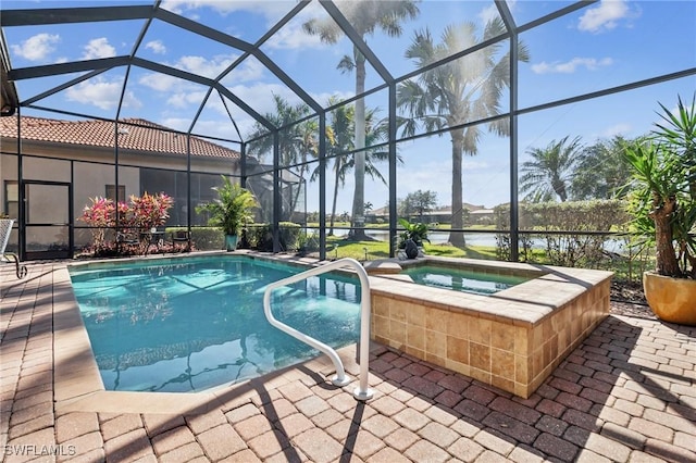 view of pool featuring an in ground hot tub, a water view, a patio, and glass enclosure