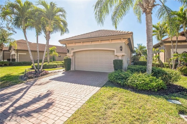 mediterranean / spanish house with a garage and a front lawn