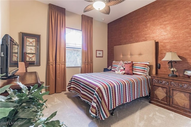 bedroom featuring ceiling fan and carpet