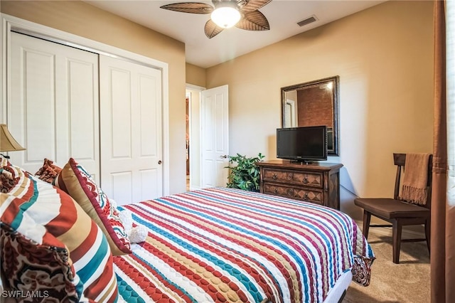 carpeted bedroom featuring ceiling fan and a closet