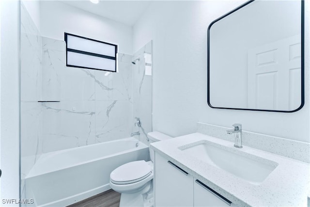 full bathroom featuring vanity, toilet, hardwood / wood-style floors, and tiled shower / bath combo