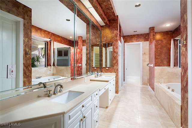 bathroom featuring vanity, tiled tub, and tile patterned floors