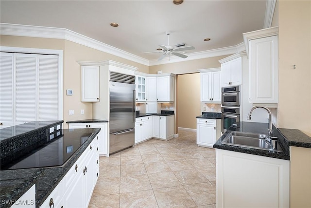 kitchen featuring sink, white cabinetry, light tile patterned floors, and appliances with stainless steel finishes