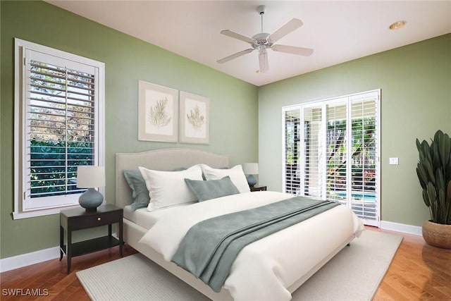 bedroom featuring ceiling fan, wood-type flooring, and access to outside