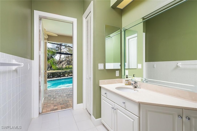 bathroom featuring tile walls, vanity, and tile patterned flooring