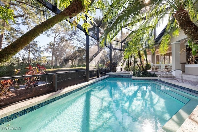 view of pool with an in ground hot tub, a lanai, and a patio area