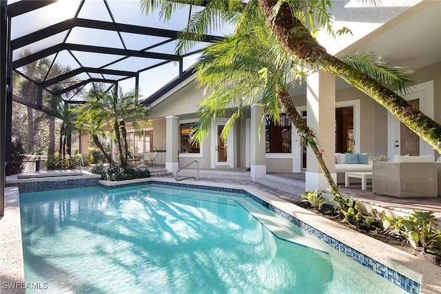 view of swimming pool with an in ground hot tub, a patio area, glass enclosure, and an outdoor hangout area