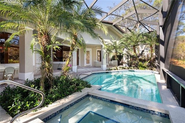 view of pool with an in ground hot tub, a lanai, and a patio