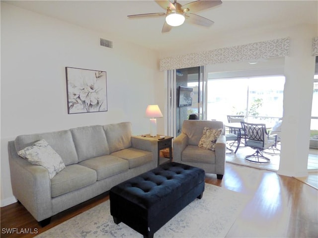 living room with ceiling fan and hardwood / wood-style floors