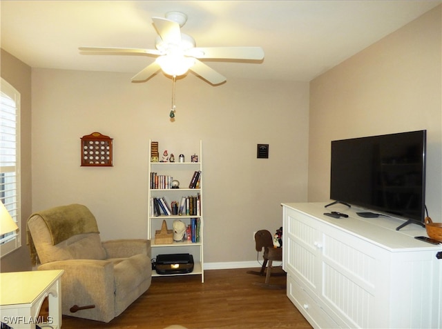 sitting room with ceiling fan and dark hardwood / wood-style flooring