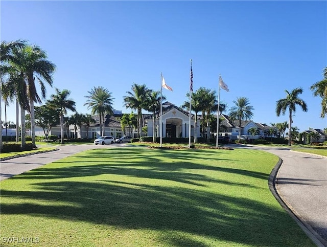 view of home's community with a yard