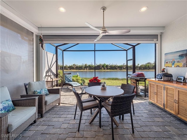 view of patio / terrace featuring a lanai, a water view, and outdoor lounge area