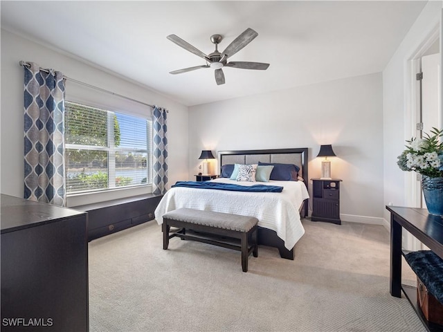 bedroom featuring ceiling fan and light carpet