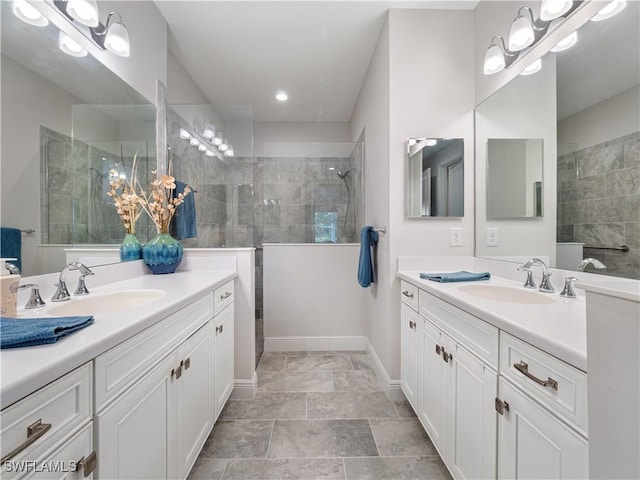 bathroom with vanity and a tile shower